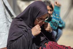 سُهيلا بني عيسى تتحدى النزوح بتطريز الفساتين التراثية (صور)