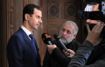 بشار الأسد أثناء مقابلة مع وسائل الإعلام البلجيكية (أ ف ب)