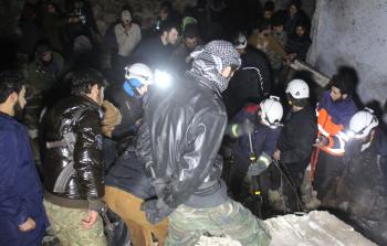 عمال الإنقاذ ينتشلون الضحايا من تحت أنقاض مبنى قصفته قوات النظام السوري في تفنتاز (أ ف ب)