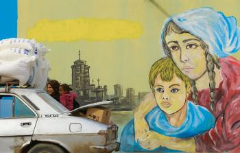 امرأة فلسطينية تتسلم المساعدة الإغاثية الشهرية من 