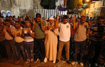 فلسطينيون يؤدون الصلاة أمام الأقصى احتجاجاً على البوابات الالكترونية (أ ف ب)