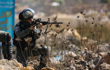 جندي إسرائيلي يصوب سلاحه تجاه الفلسطينيين (أرشيف)