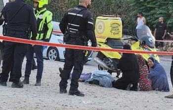 جثة الشاب القتيل في اللد وجمع من ذويه وشرطة الاحتلال في المكان