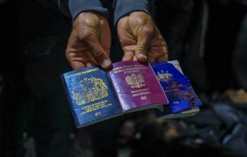 passports-aid-workers-deir-balah-gaza-2-april-afp.jpg