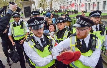 عناصر من الشرطة البريطانية يعتقلون احدى المحتجات (أرشيف)