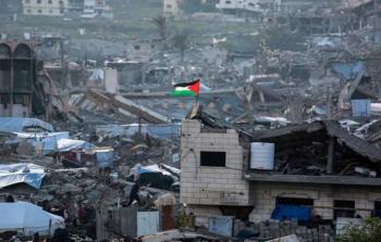علم فلسطيني يرفرف وسط أنقاض المباني في بيت لاهيا شمال قطاع غزة