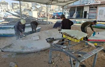 صيادون فلسطينيون يعملون على إصلاح مراكبهم داخل ميناء غزة البحري